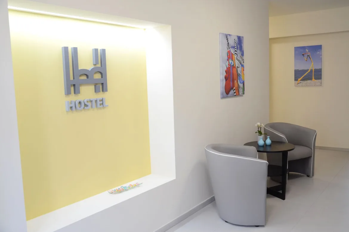 Entrance hall with armchairs and hostel logo