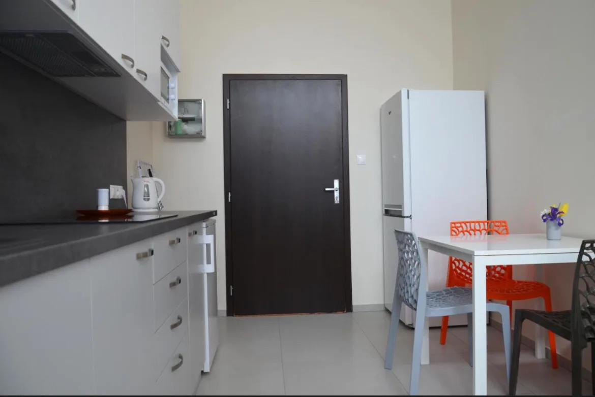 Shared kitchen with refrigerator and dining table